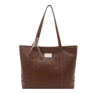 Brown faux leather tote bag with embossed cat patterns and bow decoration