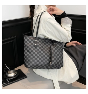 Close-up of geometric pattern tote bag with matching pouch and durable shoulder straps