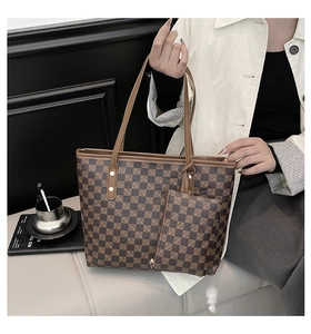 Detail of checkered tote bag with matching zipper pouch and durable handle for daily use