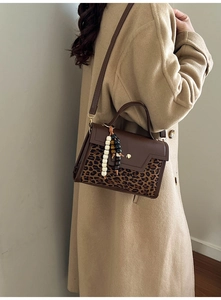 Brown faux leather baguette bag with leopard print panel and beaded charm detail