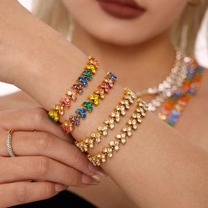 Golden bracelet set with rainbow zircons and pavé diamonds for women in luxury style