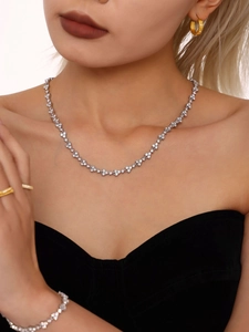 Close-up of luxury full zircon flower necklace and bracelet set on model with silver finish