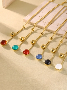 Close-up of colorful resin pendants on 18K gold plated chains with sliding bead detail