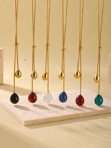 Macro display of six colorful resin waterdrop tassel pendants on gold plated snake chains