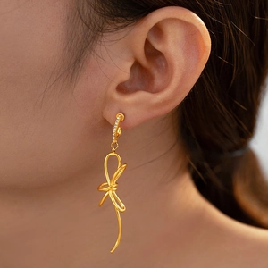 Bohemian gold bow earrings with 18k plating and sparkling cubic zirconia stones