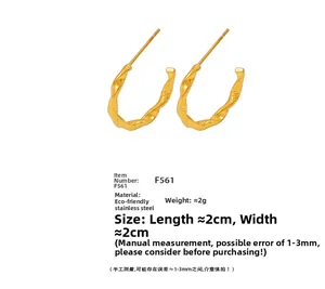 Macro shot of 2cm twisted rope texture C-shaped hoop earrings in 18K gold plated steel