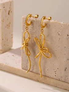 Detailed view of 18K gold plated bow earrings with sparkling micro-pave crystals