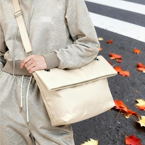 Minimalist beige oversized hobo bag in smooth glossy fabric for autumn street style