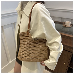 Detail of woven straw texture and durable brown leather straps with metal rivets