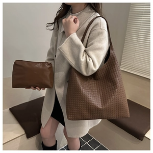 Detail of vintage brown woven tote bag with matching inner pouch for daily commuting