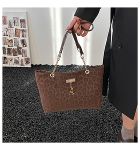 Leopard print tote bag with gold chain strap and signature deer pendant detail