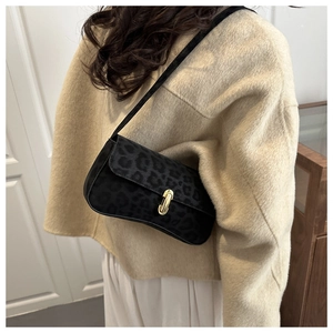 Detail view of black leopard print underarm bag with gold metal U-shaped lock buckle