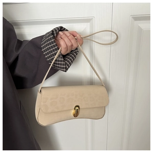Detail of beige leopard embossed suede bag with gold twist lock and elegant thin strap