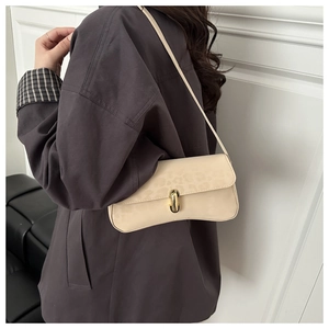 Close-up of beige leopard print shoulder bag featuring textured fabric and gold oval lock