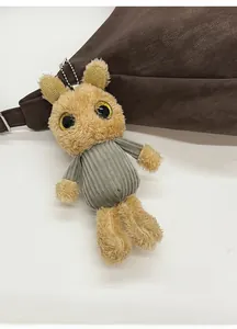 Close-up of rabbit plush keychain with grey knit sweater and sequin eye details