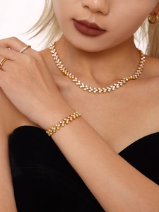 Detail of 18K gold plated stainless steel jewelry set with pavé zircon on model
