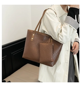 Detail of dark brown woven tote bag showing leather texture and matching coin purse