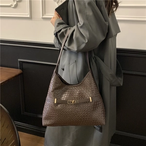 Dark brown woven leather hobo shoulder bag with gold hardware and minimalist design