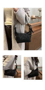 Detail of black leopard print shoulder bag with silver buckle and adjustable strap