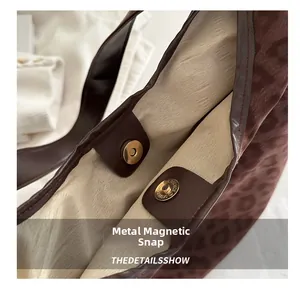 Detail of the magnetic clasp and interior lining of the leopard print tote bag