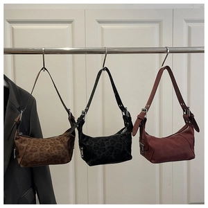 Three retro suede tote bags in leopard print and solid red colors with wide straps