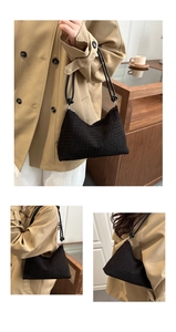 Detail of black quilted fabric tote bag showing stripe texture and chic trapezoid design