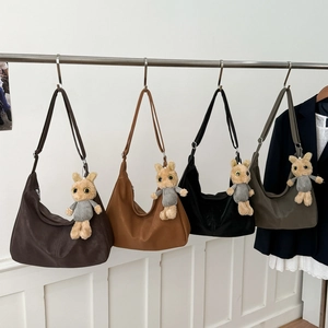 Minimalist half-moon tote bags in brown, black and green with cute rabbit charms