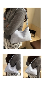 Detailed view of light blue corduroy shoulder bag with textured stripes and knotted strap