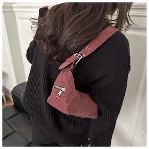 Close-up of matte dark red vintage hobo bag with wide shoulder strap and silver hardware