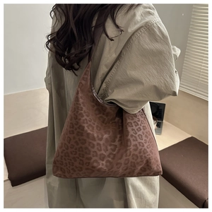 Detailed close-up of brown leopard print PU shoulder bag worn with a casual trench coat