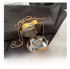 Detailed internal view of heart-shaped gold metal mini bag for wireless earphones