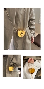 Macro view of gold mirror finish heart mini bag with thin metal chain strap