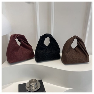 Three leopard print suede tote bags with twist knot handles in red, black and brown