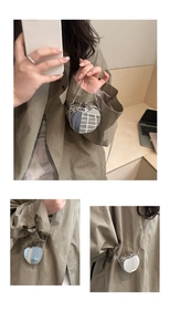 Three-way view of a silver heart-shaped mirror box bag with metallic chain strap
