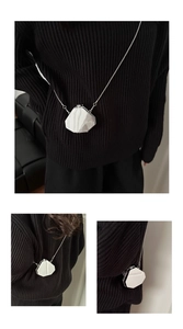 Three views of a silver octagonal mirror acrylic mini box bag with a metal chain strap