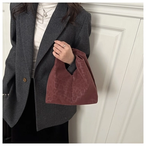 Burgundy leopard print tote bag with ruched design shown on a model in a fashion outfit
