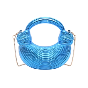 Metallic blue shell bag with wave ripples, crescent shape and gold chain strap