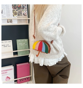 Detail shot of a creative rainbow umbrella cross-body bag with multi-color splicing design