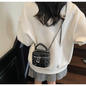 Mini black quilted leather box bag shown on model for size and style reference