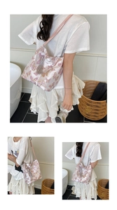 Macro detail of pink tote bag featuring purple butterfly patterns and decorative grey tassel