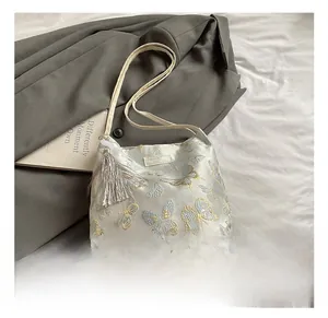 Detail of Chinese style floral butterfly embroidery and elegant tassel on handbag