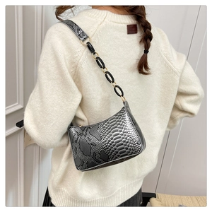 Detailed close-up of metallic snake skin texture on this trendy hobo bag for women