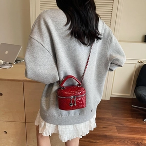 Red patent leather quilted mini box bag with chain strap and heart pendants