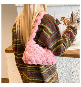 Close-up of pink faux fur tote bag showing soft bubble texture and wide shoulder strap