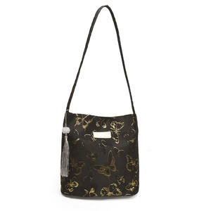 Minimalist black bucket bag with golden butterfly pattern and elegant tassel pendant