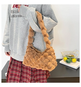 Detail of brown plush popcorn texture shoulder bag with soft faux fur for autumn winter