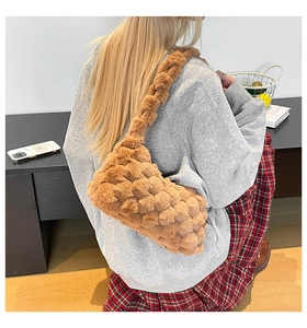Detail of brown fuzzy crossbody bag featuring textured 3D woven grid plush material