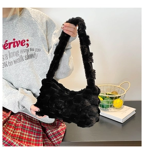 Macro detail of black plush tote bag featuring soft woven texture and fuzzy material