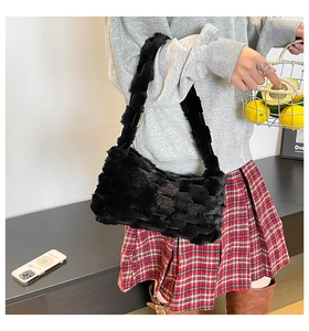 Detail of black faux fur woven tote bag with soft plush texture for autumn fashion