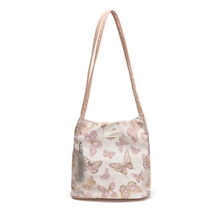 Elegant embroidered butterfly tote bag in cream with pink straps and plush pendants